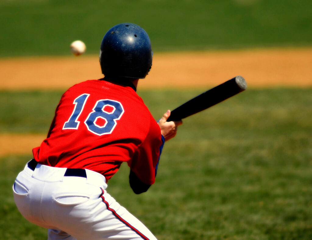 Baseball player preparing to bunt a pitch